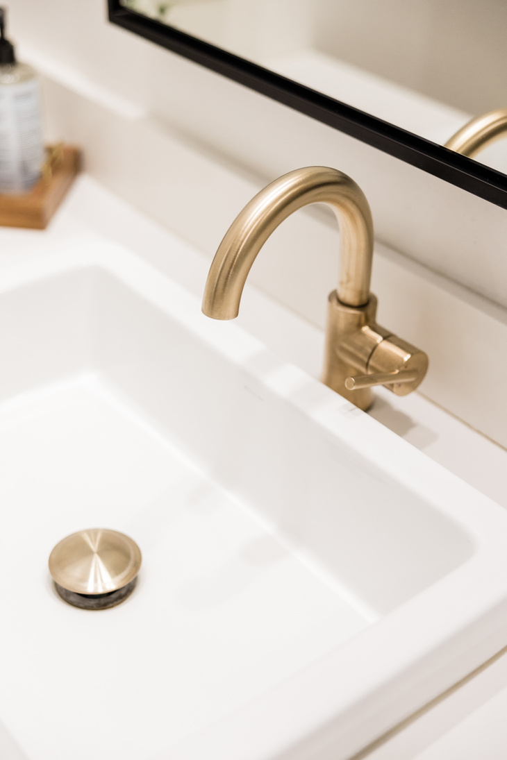Golden Faucet on White Ceramic Sink